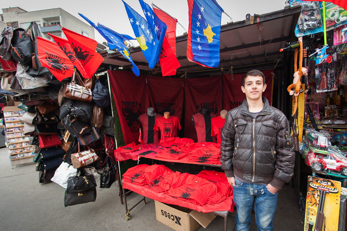 An Albanian young man proudly sells patriotic items in Skopje, Macedonia