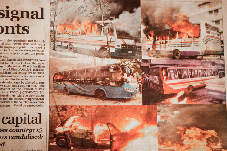 A newspaper in Dhaka reporting about the buses that were attacked that morning