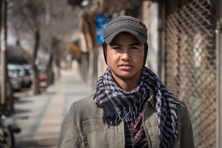 An Afghan refugee poses in front of my camera on the streets of Yazd