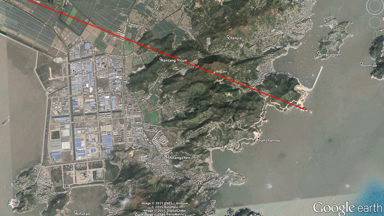 The location in China where the route touches the Pacific Ocean, in the middle of an industrial area