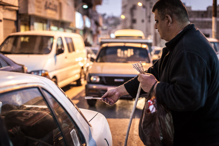 Blind and deaf at the same time. This man roams the streets of Amman selling pencils.